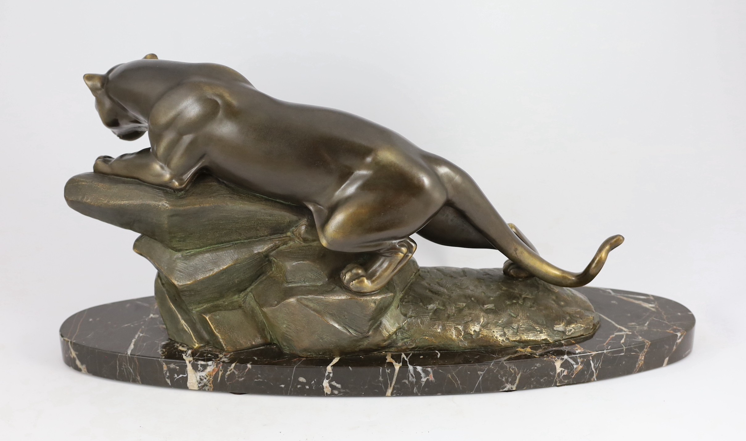 M. Leducq. NB. A patinated spelter model of a panther crouched upon a rock, width 60cm height 29cm